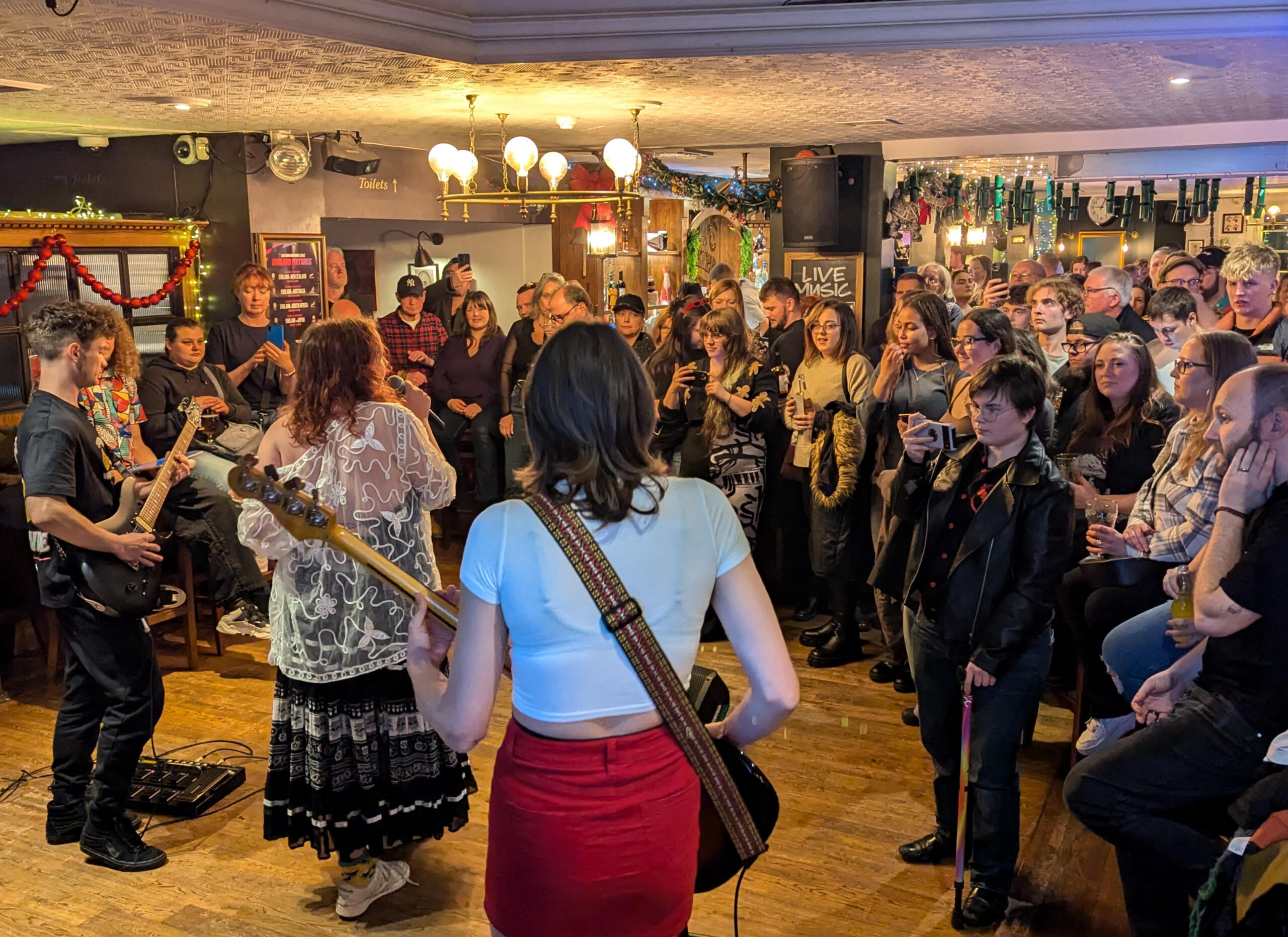 Talent show Image of a potential fringe event with a band playing to a crowd of people in a pub